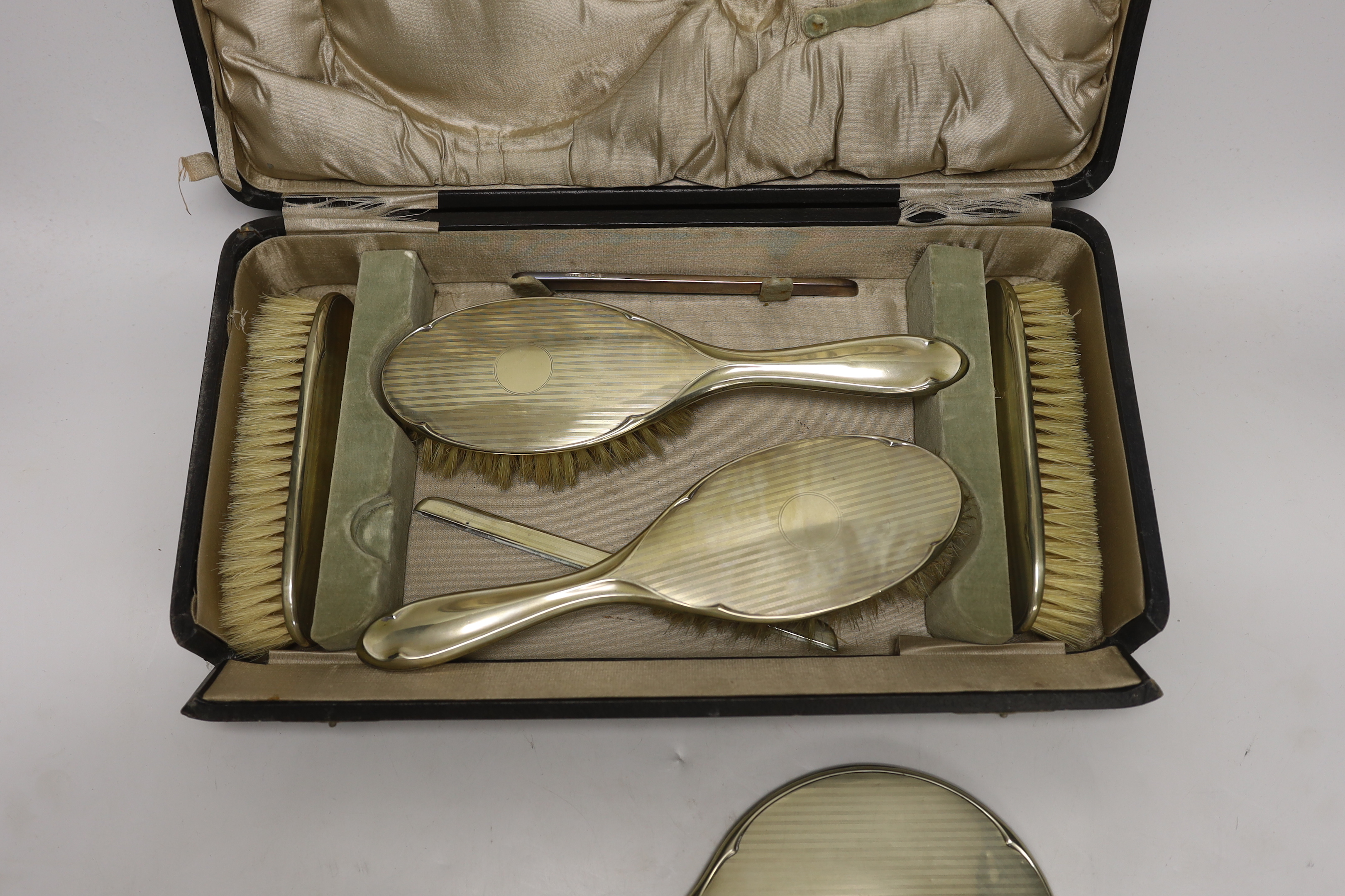 A cased 1930's six piece plated mirror and brush set.